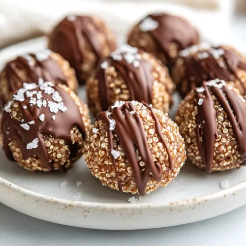 Crispy Quinoa Peanut Butter Balls: A Healthy No-Bake Treat 3 Crispy Quinoa Peanut Butter Balls Drizzled With Chocolate On A White Plate, Topped With Flaky Salt