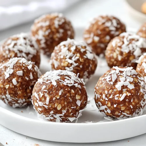 Close-Up Of No Bake Energy Balls On A White Plate, Topped With Shredded Coconut And Cinnamon, In A Bright, Natural Setting