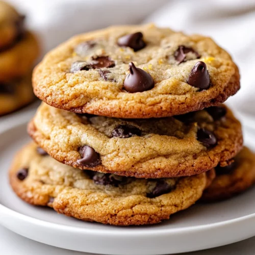 Soft And Chewy Orange Chocolate Chip Cookies Everyone Will Love 3 Stack Of Orange Chocolate Chip Cookies On A White Plate, Showcasing Crispy Edges And Melted Chocolate Chips