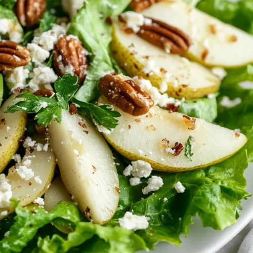 Roquefort Pear Salad With Candied Pecans &Amp; Avocado 3 Roquefort Pear Salad Served On A White Plate, Topped With Candied Pecans And Fresh Parsley