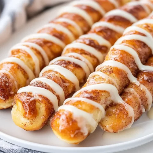 Sourdough Discard Cinnamon Breadsticks Recipe For Sweet Perfection 3 Sourdough Discard Cinnamon Breadsticks On A White Plate Drizzled With Cream Cheese Glaze And Garnished With Cinnamon Sugar