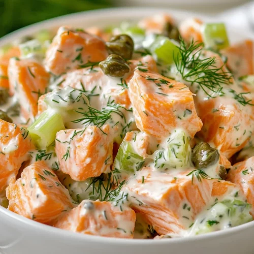 Healthy Salmon Salad In A White Bowl Garnished With Dill And Capers, Served With Lemon Wedges On The Side