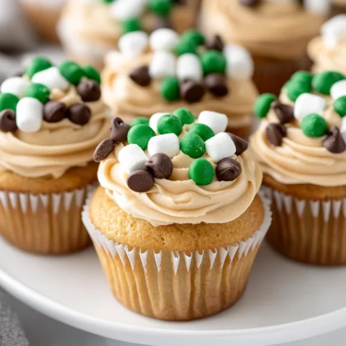 Perfect Pull Apart Football Cupcakes – A Game Day Treat! 3 Festive Pull Apart Football Cupcakes With Peanut Butter Frosting And Chocolate Chips On A White Plate
