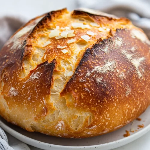 Freshly Baked San Francisco Sourdough Bread On A White Plate, Topped With Chopped Onions And In Soft Natural Light.